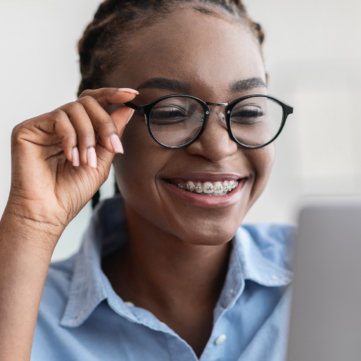 smiling teenage girl with glasses smiling with her braces